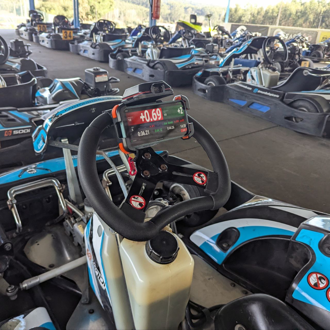 Kart racer checking RaceCling telemetry data during pitstop